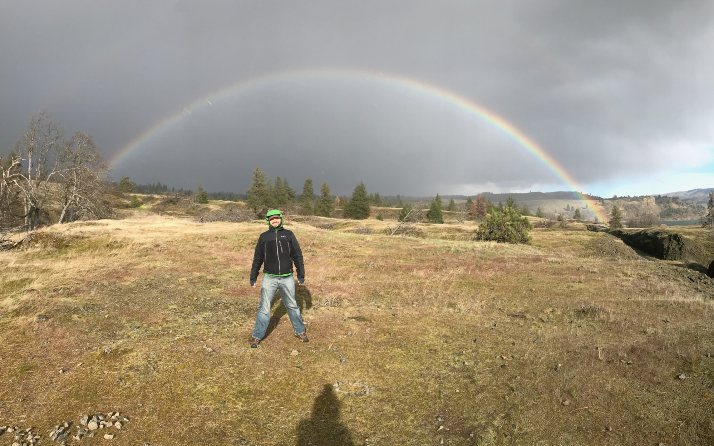 Peter smiling with sunglasses and a rainbow lens flare